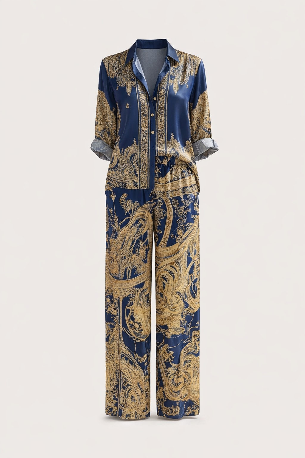 Navy two-piece set with a gold baroque print, a button-front shirt with rolled contrast cuffs and matching wide-leg pants