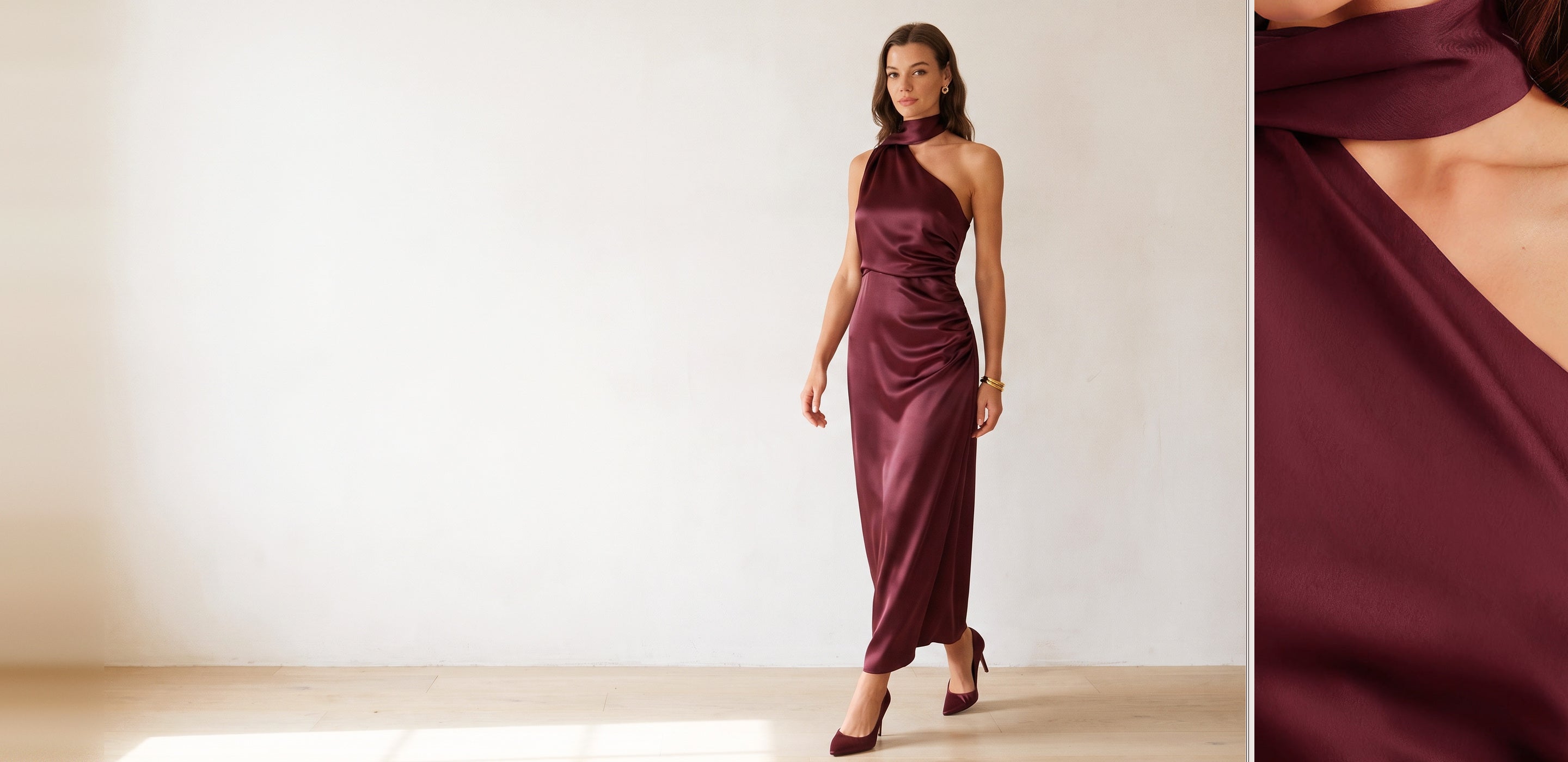 Woman in a wine one shoulder satin maxi dress in a sunlit ivory room, with a detail of the twisted halter