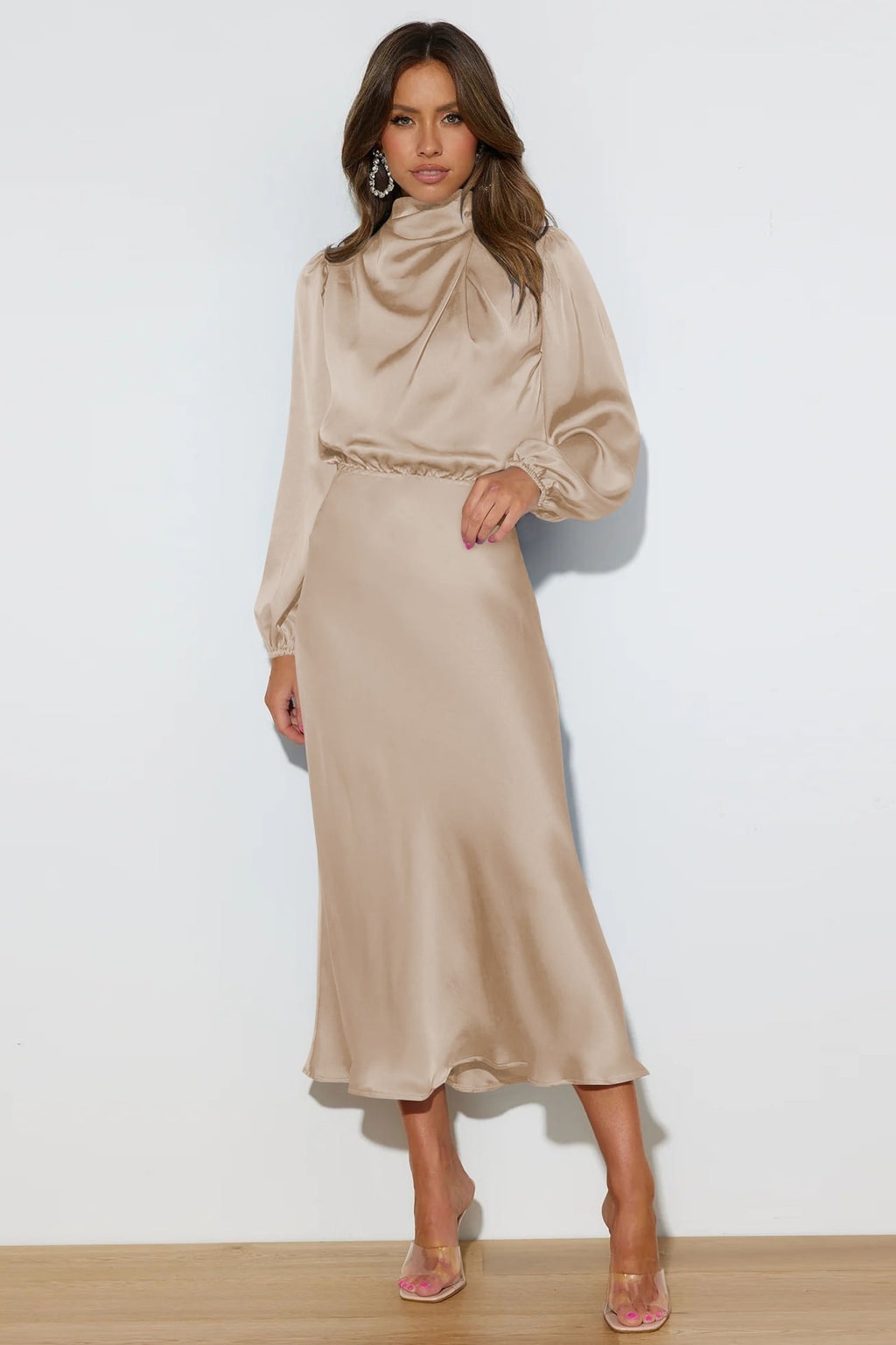 Model wearing the champagne satin midi dress with clear heels, showing the blouson bodice, elasticated waist and the hem falling just above the ankle