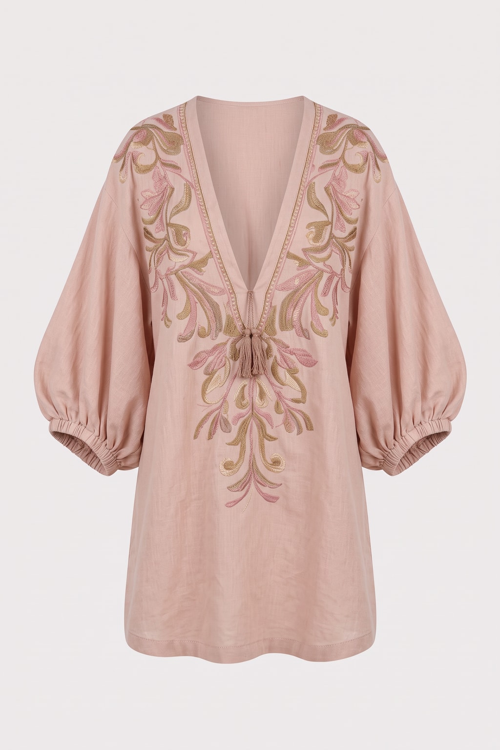Dusty pink linen mini dress with pink and gold floral embroidery, a deep V-neck with tassel ties and balloon sleeves