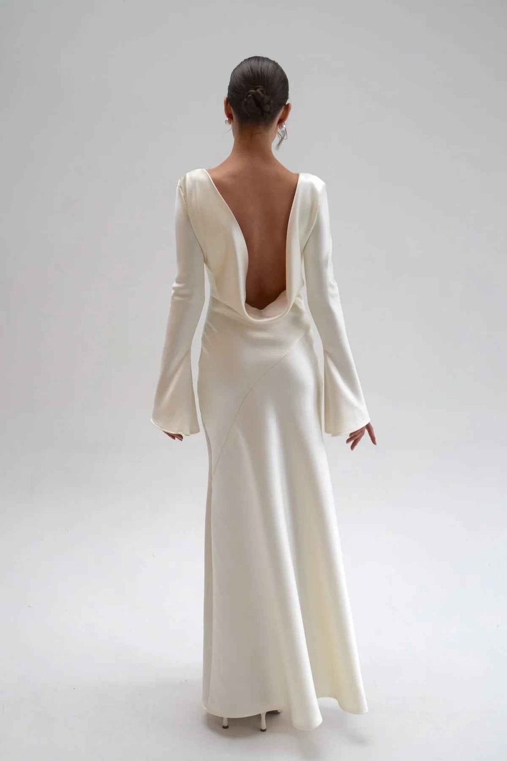 Straight back view of the satin maxi dress with deep open cowl back and floor-length flared hem