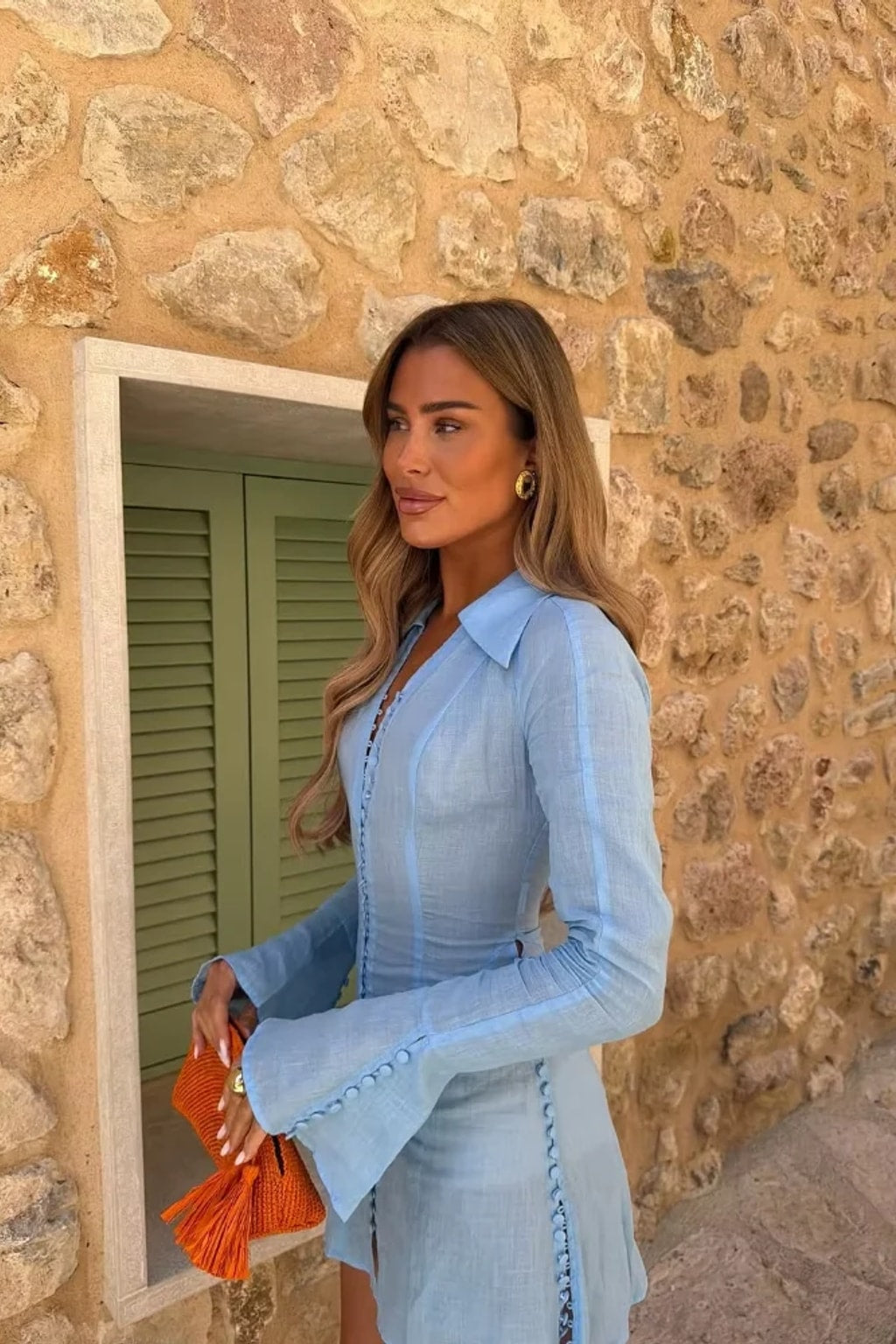 Pale blue collared A-line mini dress with rows of self-covered buttons down the front, side seams and flared cuffs