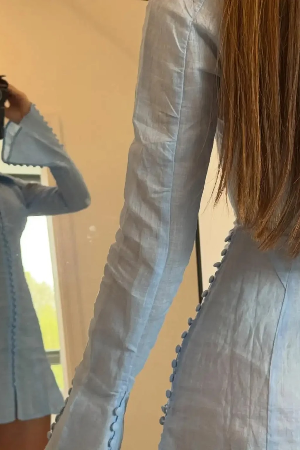 Pale blue collared A-line mini dress with rows of self-covered buttons down the front, side seams and flared cuffs