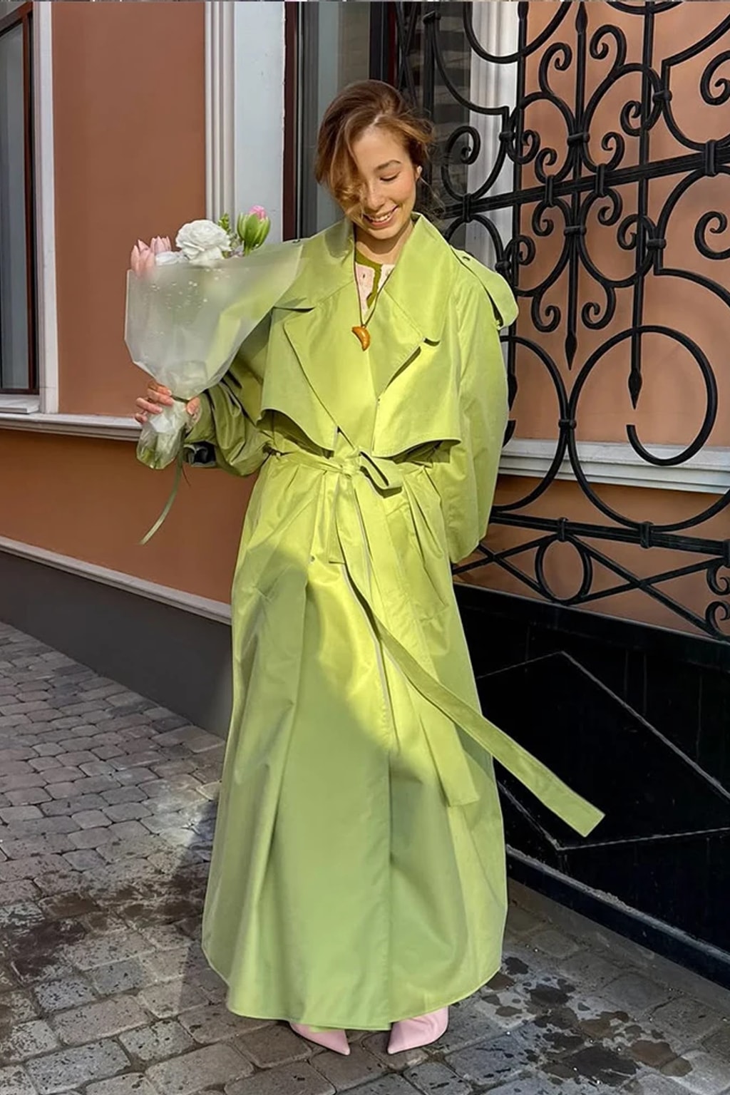 Lime green oversized maxi trench coat with a wide self-tie belt, storm flap and buckled cuff tabs