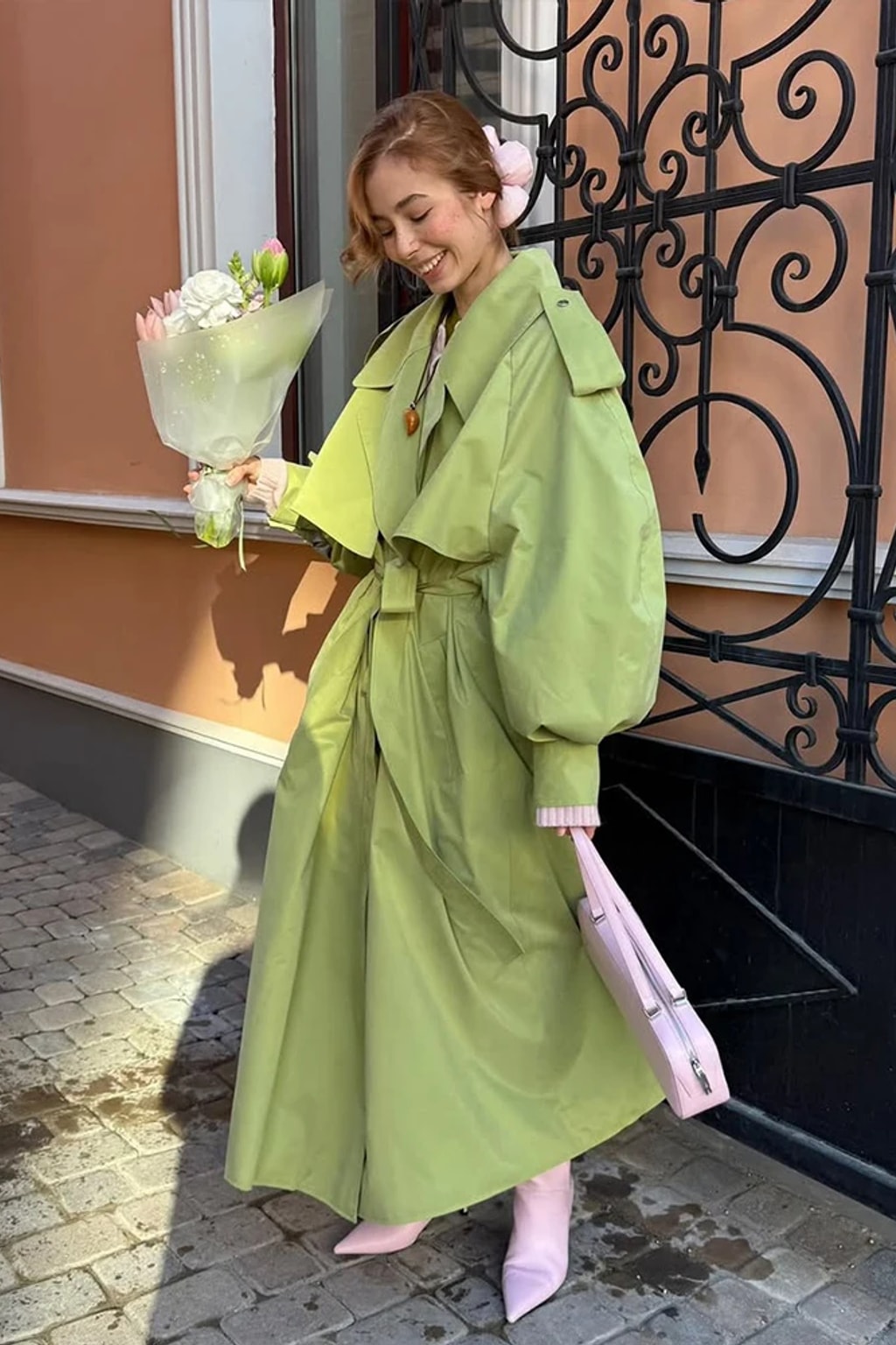 Lime green oversized maxi trench coat with a wide self-tie belt, storm flap and buckled cuff tabs