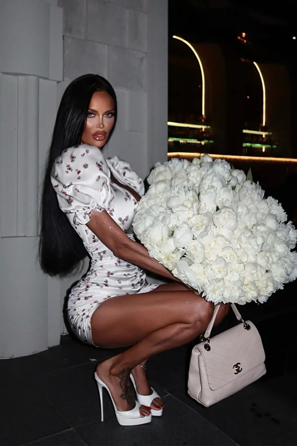 White satin mini dress with a ditsy rose print, deep V neckline, puff sleeves and ruching through the body