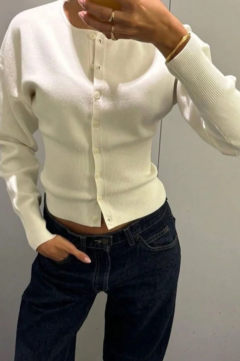 Pink cropped knit cardigan with a scalloped button placket and a deep ribbed waistband