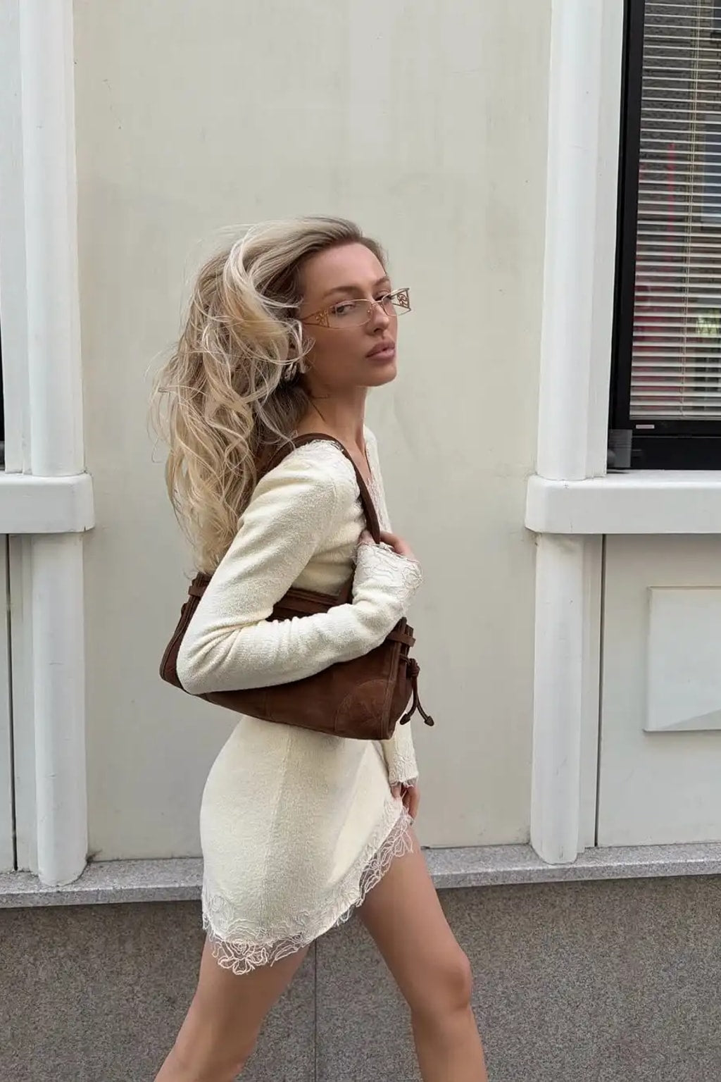 Cream fine knit mini dress with eyelash lace panels set diagonally across the body and an asymmetric lace hem