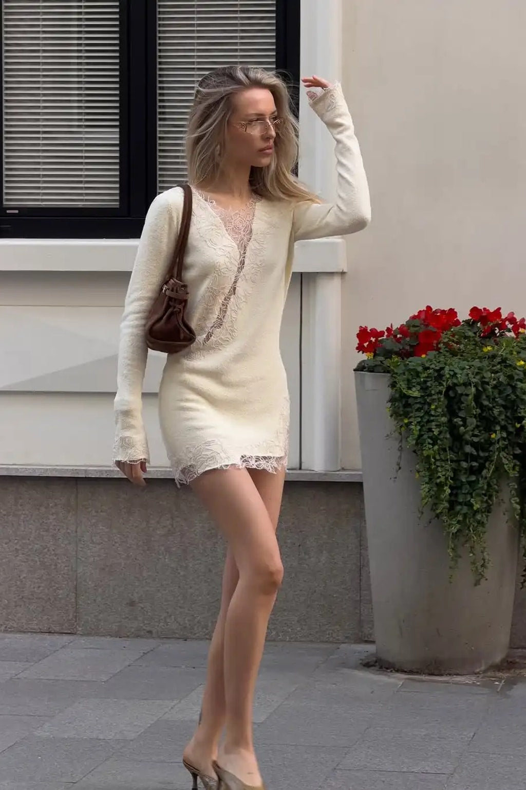 Cream fine knit mini dress with eyelash lace panels set diagonally across the body and an asymmetric lace hem