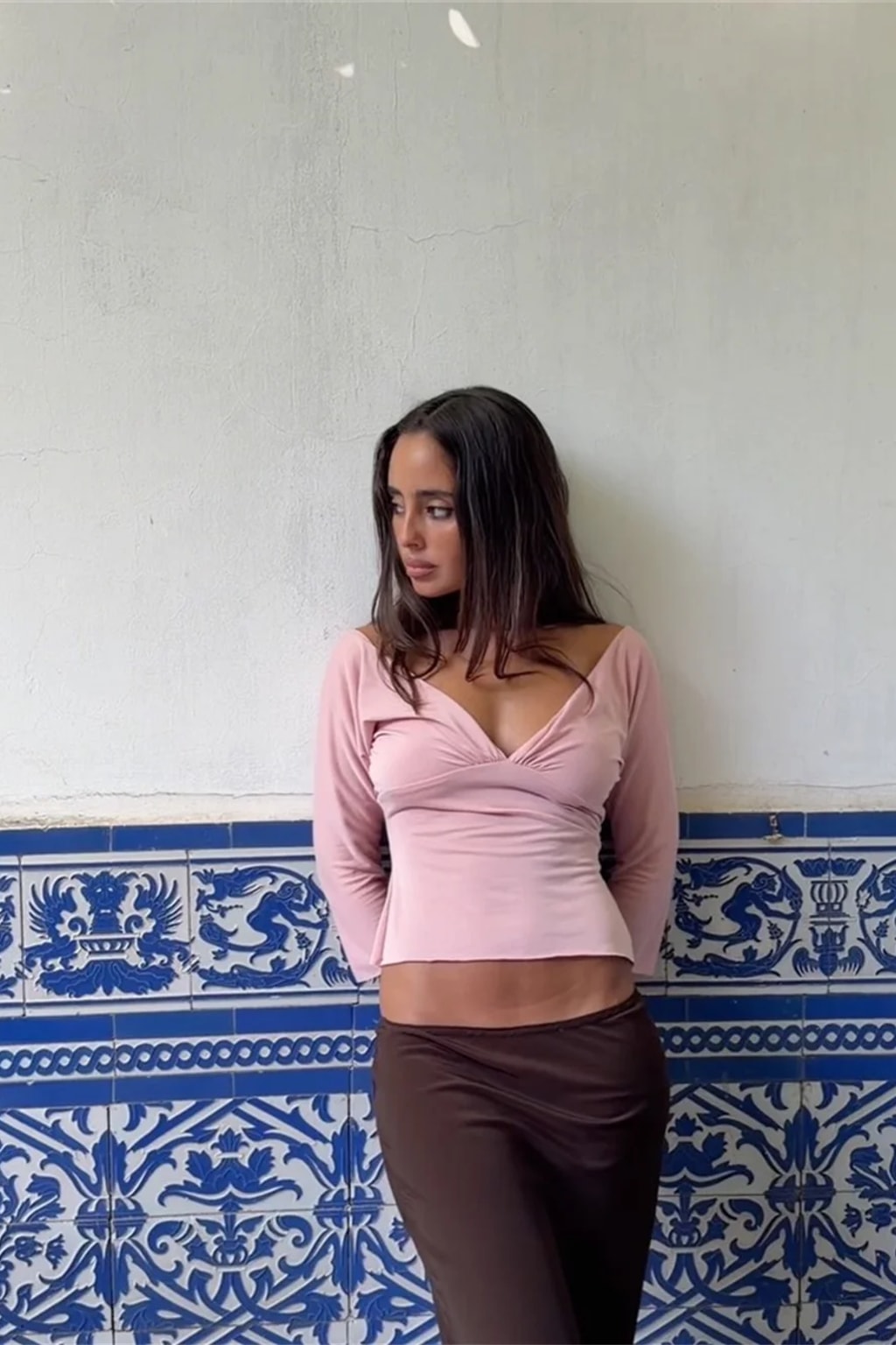 Fitted jersey crop top with a wide deep V neckline worn off the shoulder and ruching under the bust
