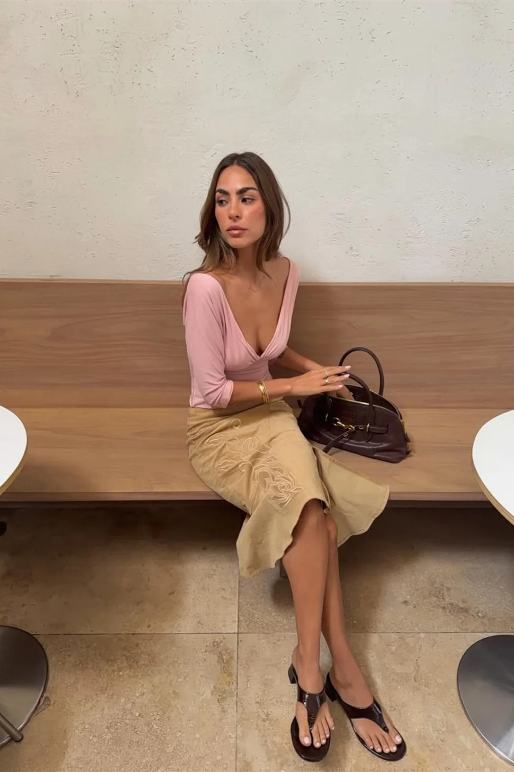 Fitted jersey crop top with a wide deep V neckline worn off the shoulder and ruching under the bust