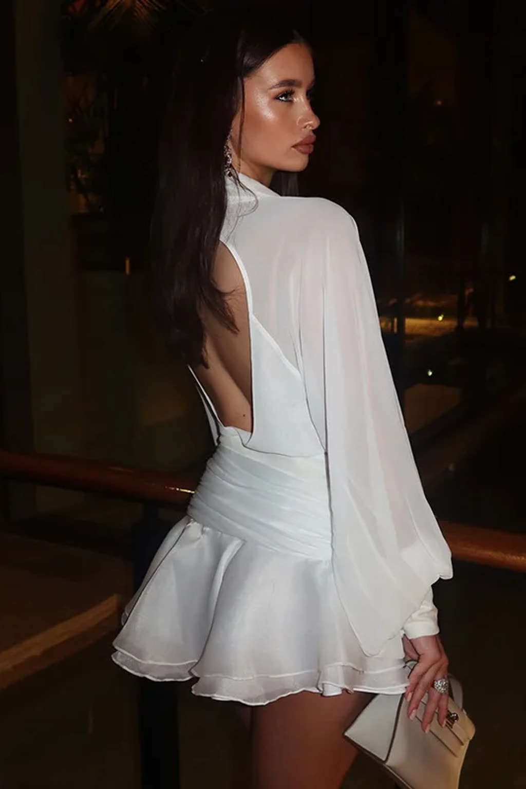 White two-piece set with an open-back chiffon blouse with balloon sleeves and a ruched-waist ruffle mini skirt