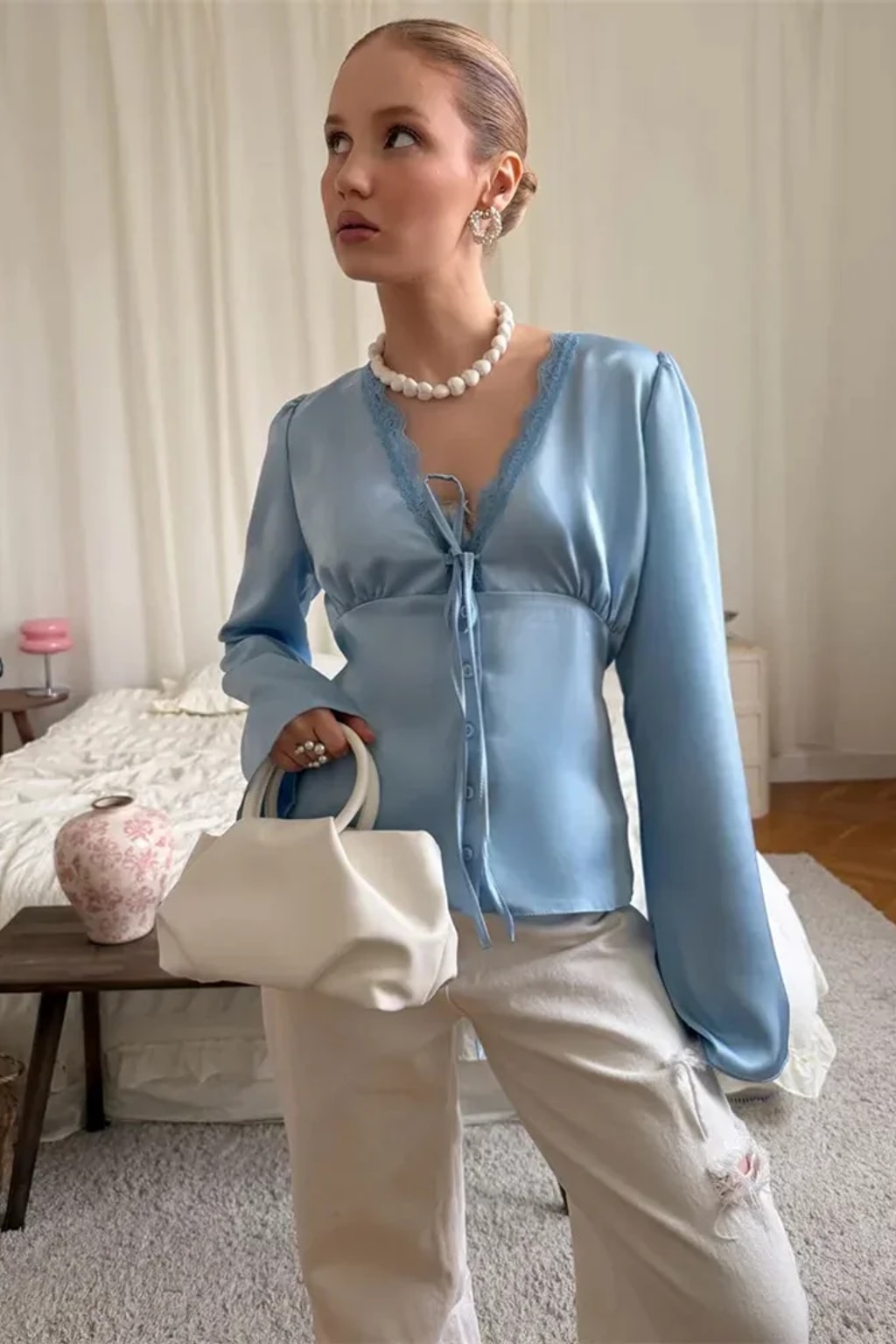 Satin blouse with scalloped lace at the deep V neckline, a tie bow and wide flared bell cuffs