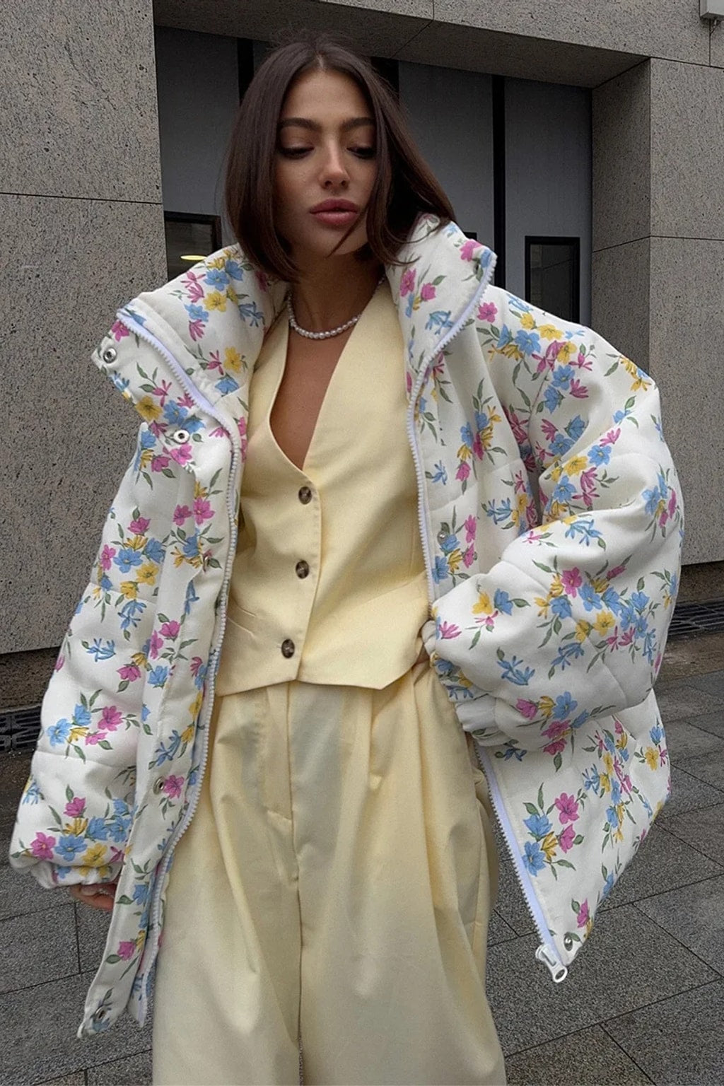 Cream oversized puffer jacket in a ditsy floral print with a tall stand collar and full zip
