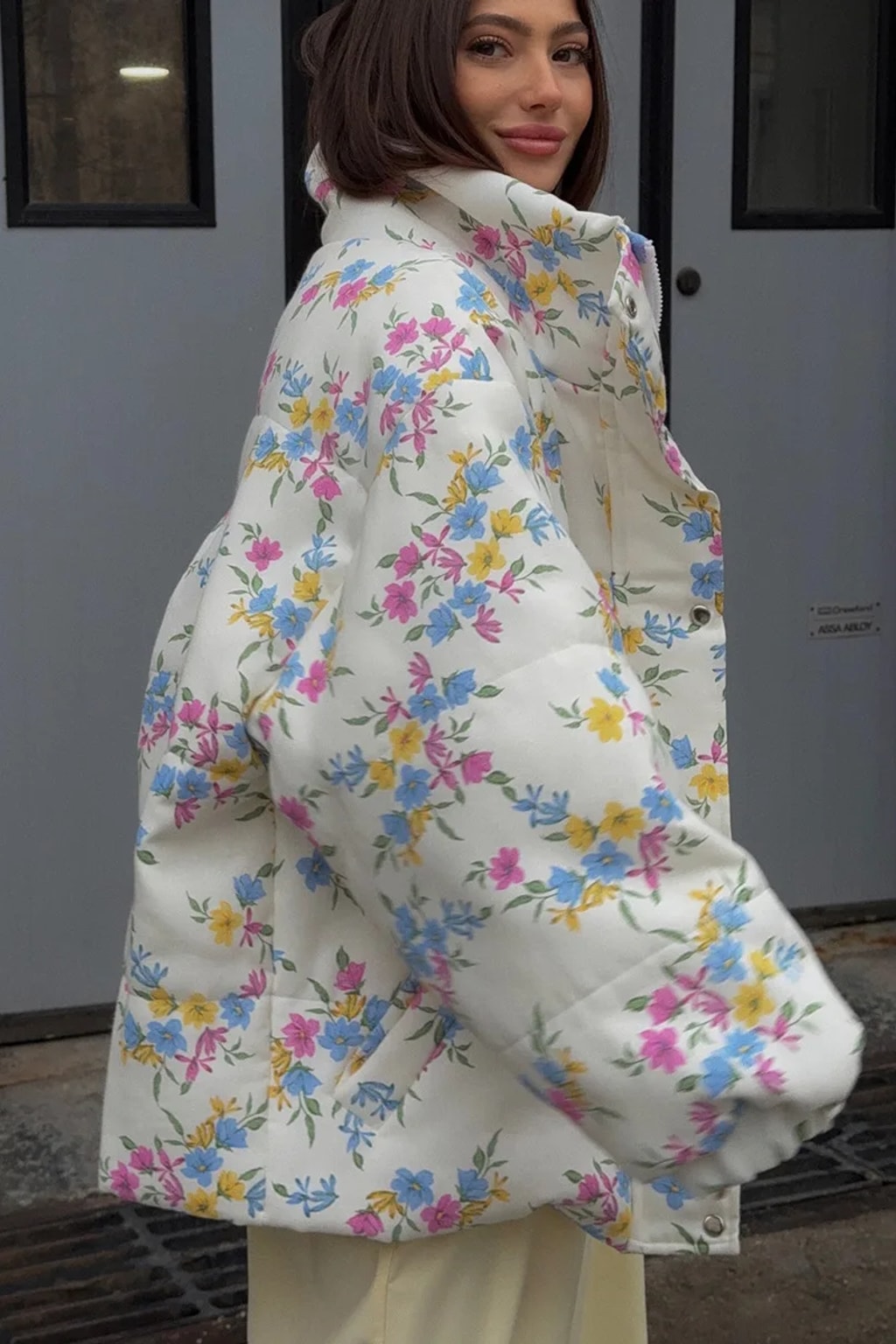 Cream oversized puffer jacket in a ditsy floral print with a tall stand collar and full zip