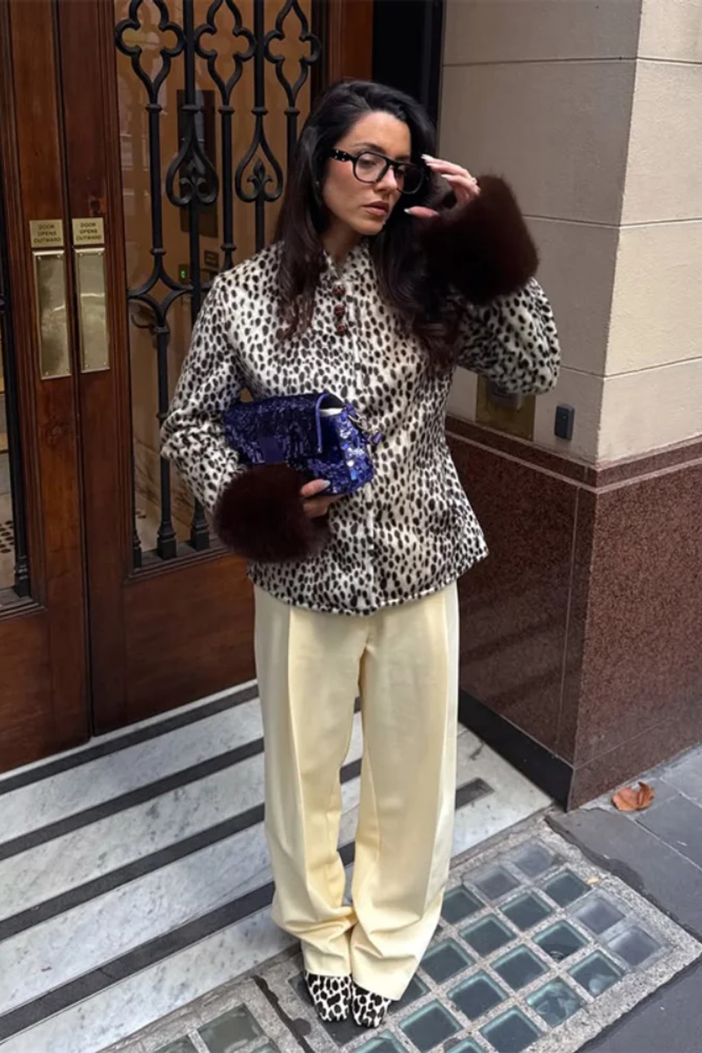 Animal print faux fur jacket with a stand collar, button front and deep contrast dark brown fur cuffs