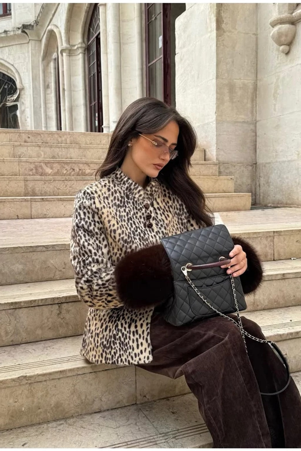 Animal print faux fur jacket with a stand collar, button front and deep contrast dark brown fur cuffs
