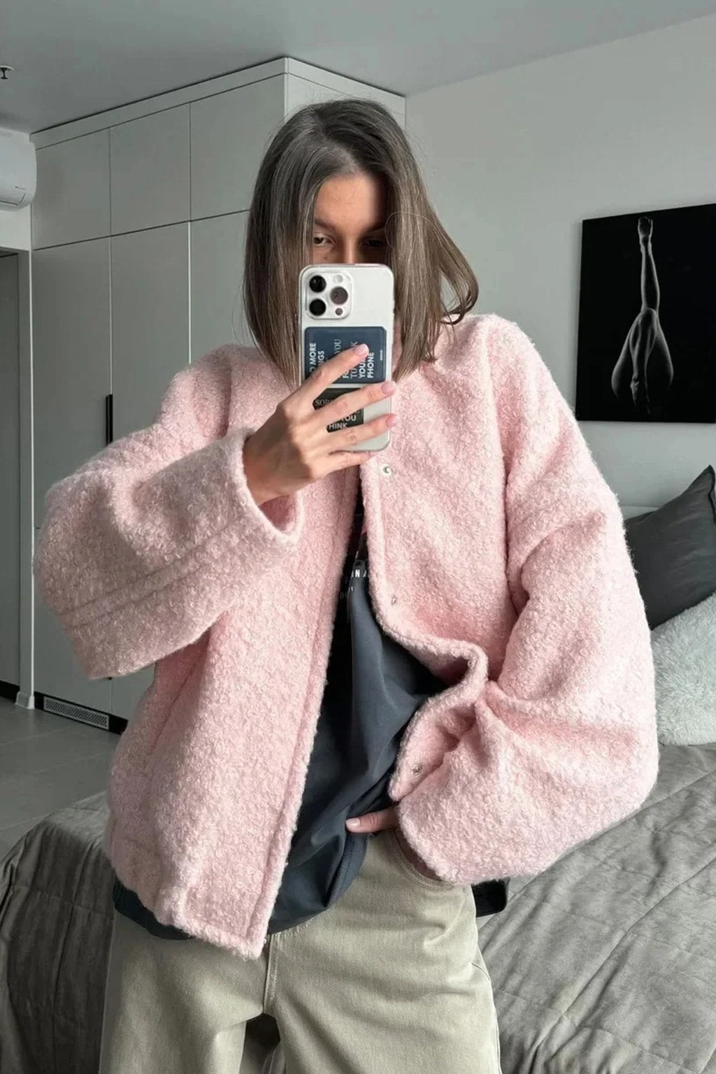 Pink boucle cropped bomber jacket with balloon sleeves, a collarless round neck and a snap front