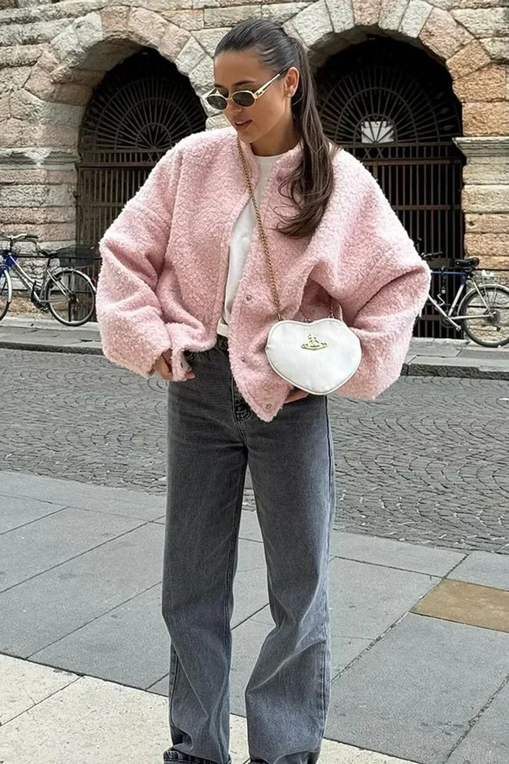 Pink boucle cropped bomber jacket with balloon sleeves, a collarless round neck and a snap front