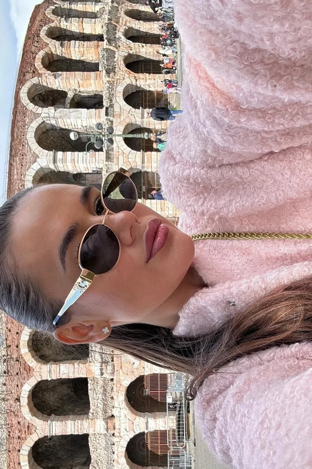 Pink boucle cropped bomber jacket with balloon sleeves, a collarless round neck and a snap front