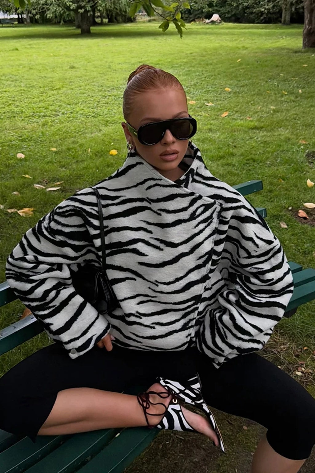 Black and white zebra print faux fur cropped jacket with an asymmetric wrap front and tall funnel collar