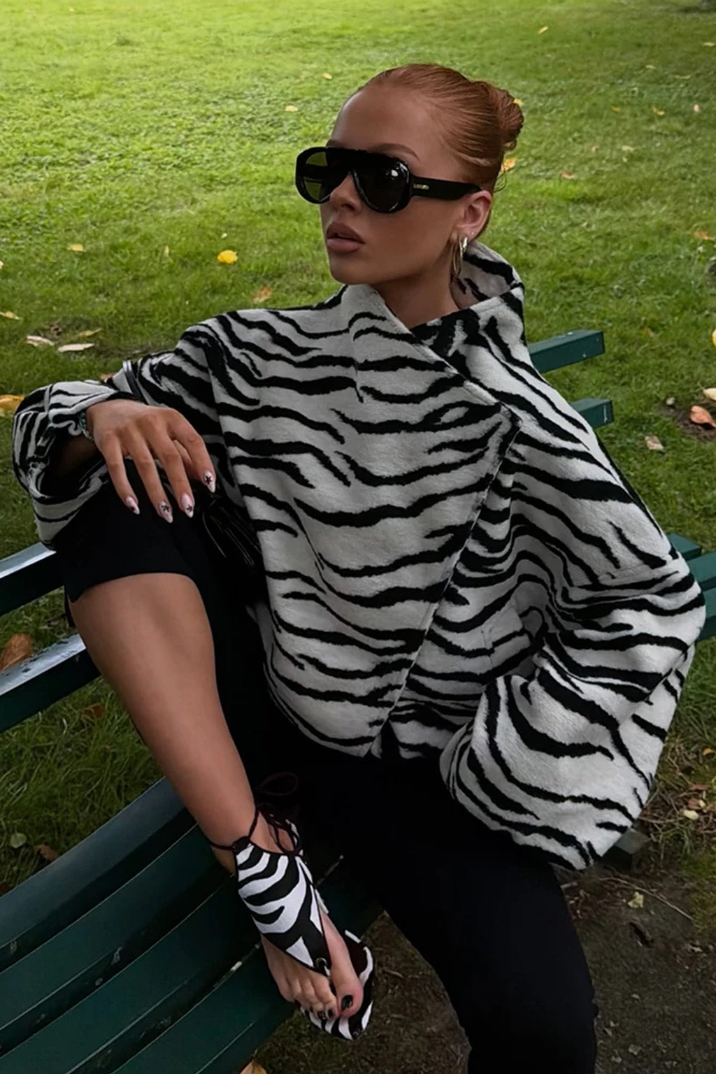 Black and white zebra print faux fur cropped jacket with an asymmetric wrap front and tall funnel collar