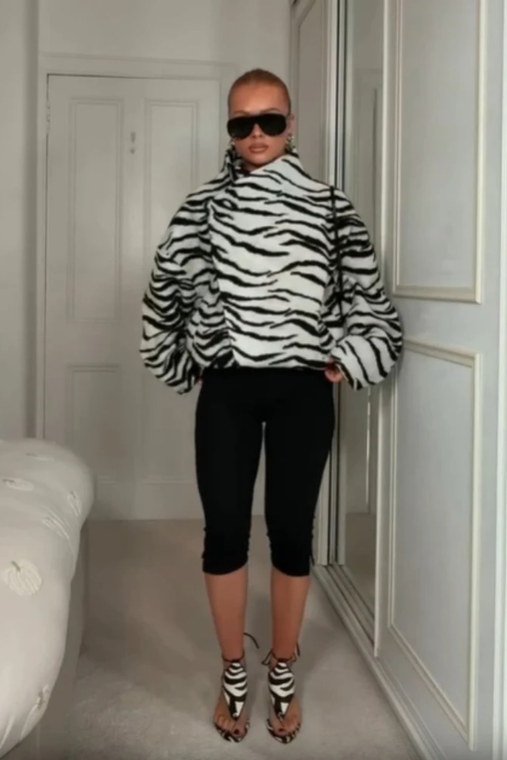 Black and white zebra print faux fur cropped jacket with an asymmetric wrap front and tall funnel collar