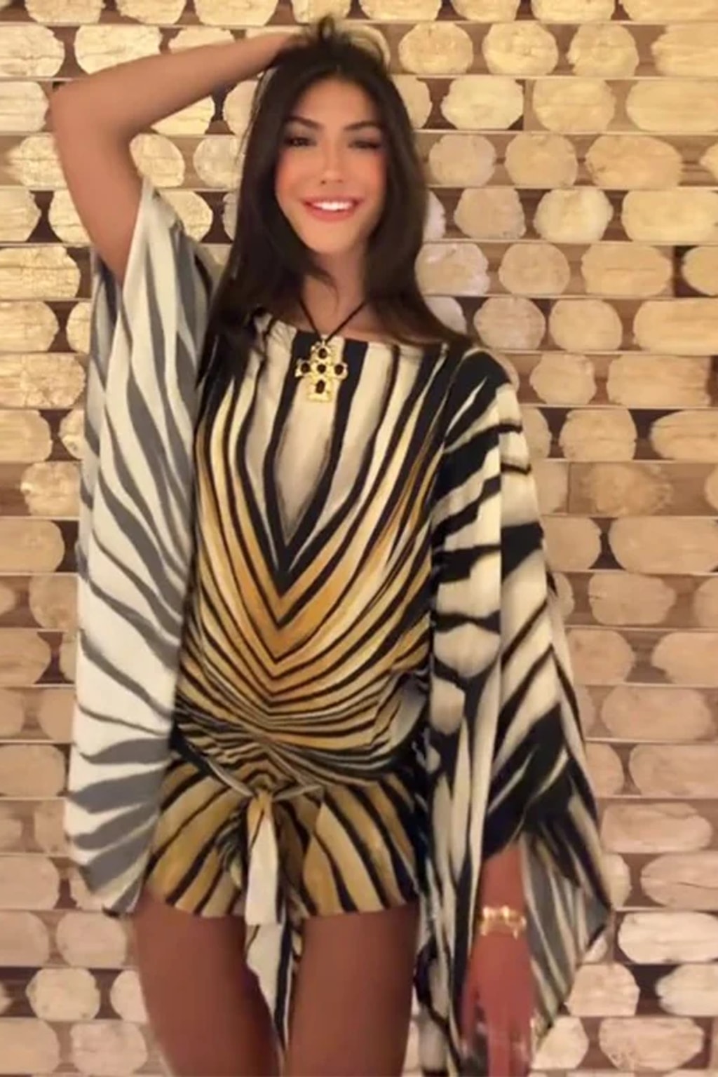 Chiffon kaftan mini dress in a radiating black, cream and gold tiger stripe with wide cape sleeves and a front tie sash
